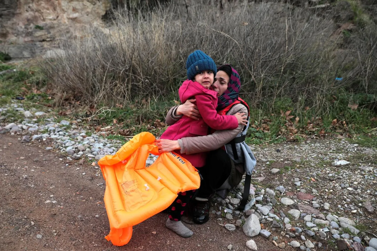 A woman and a girl cry after arriving with other migrants from Afghanistan on a beach in Greece. Reuters file photo