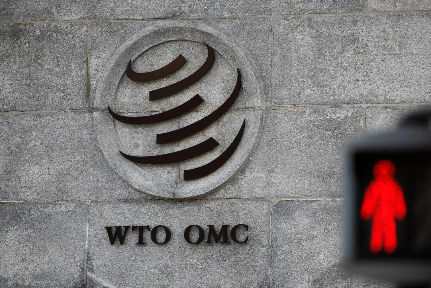 Caption: FILE PHOTO: A logo is pictured outside the World Trade Organization (WTO) headquarters next to a red traffic light in Geneva, Switzerland, October 2, 2018. REUTERS/Denis Balibouse/File Photo