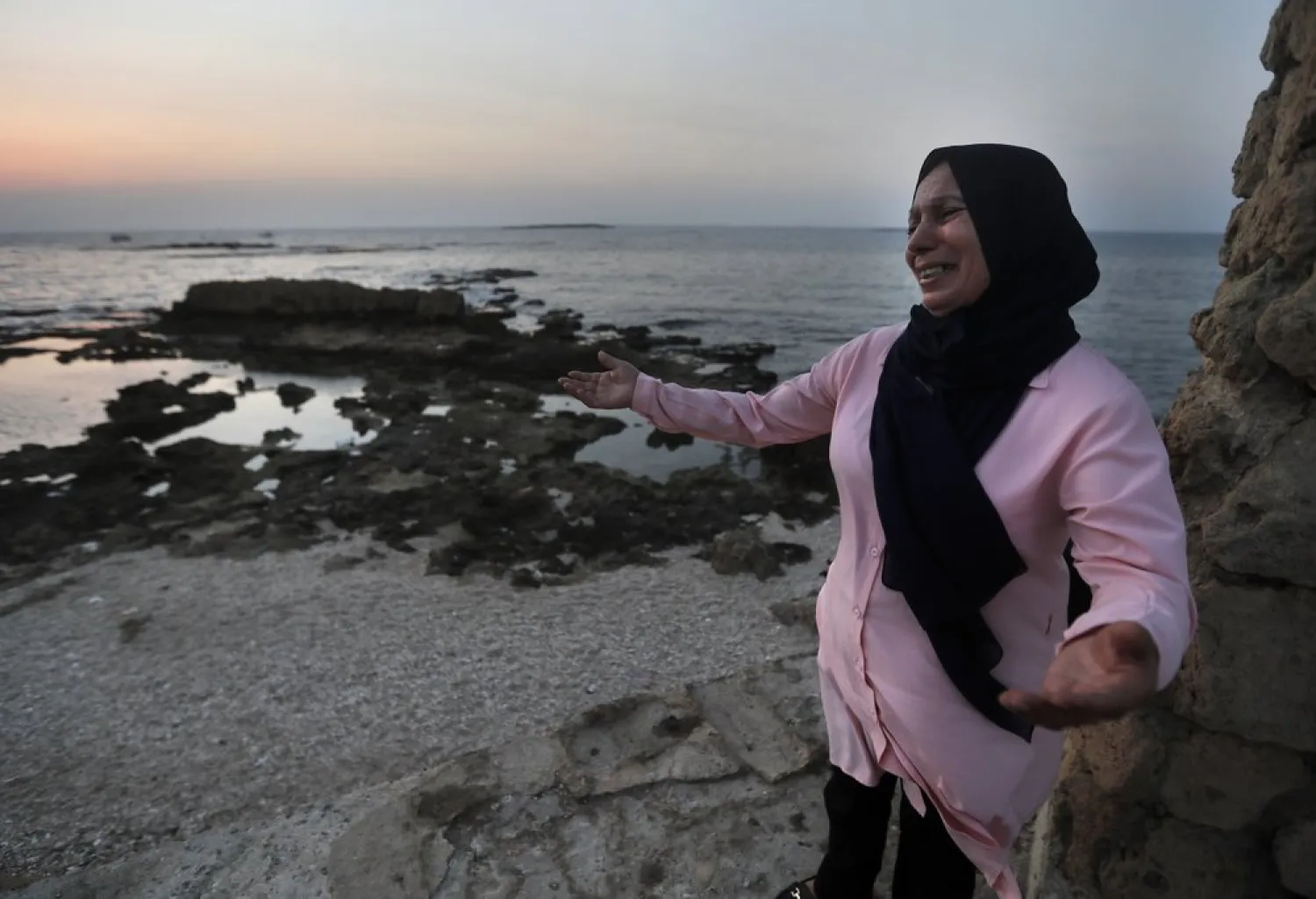 Lebanese Afaf Adulhamid the mother of Mohammed Khaldoun, 27, who tried with other migrants to reach Cyprus on a boat, as she stands on the coast of Tripoli city, north Lebanon Thursday, Sept. 17, 2020. (AP Photo/Hussein Malla)
