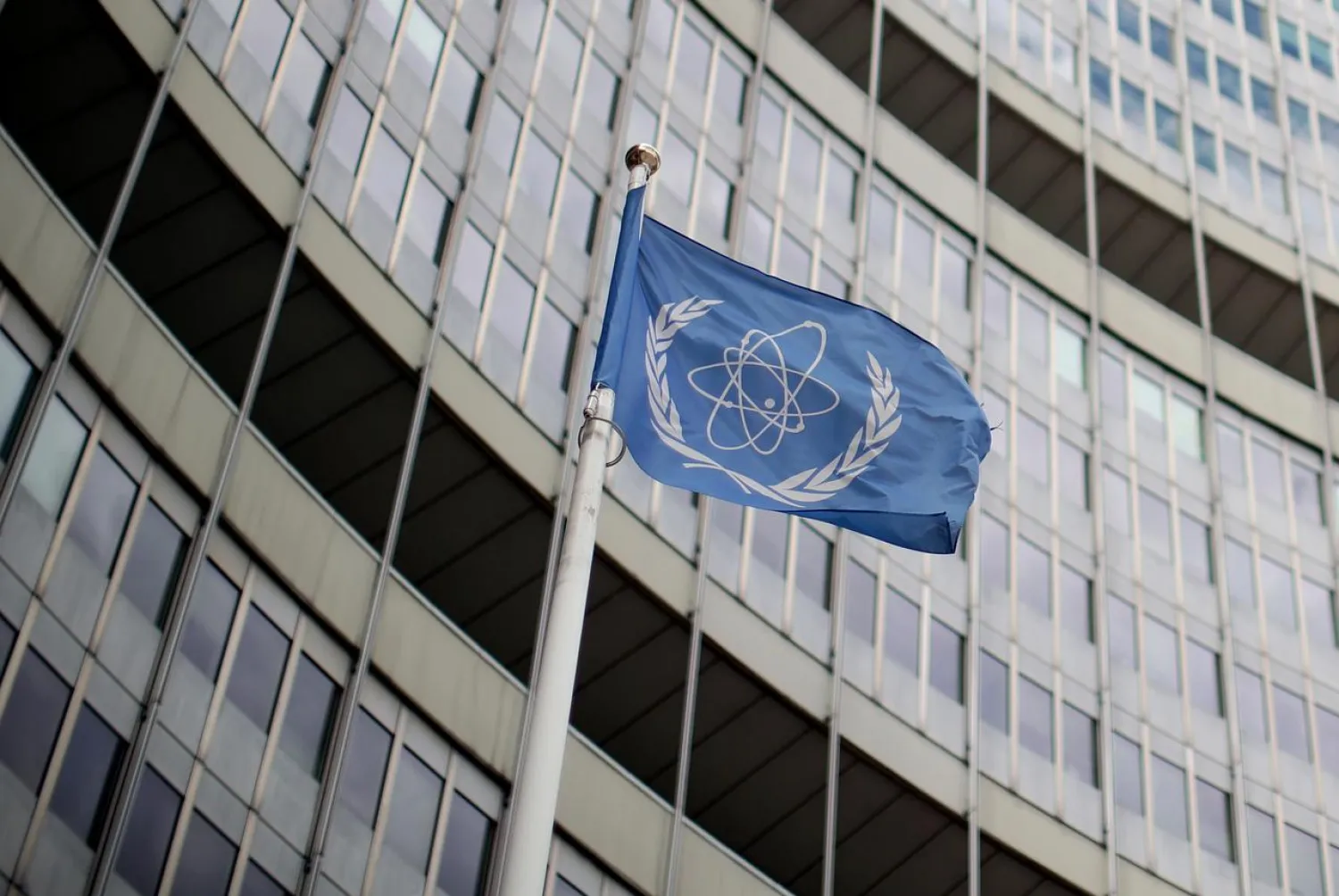 A flag with the logo of the International Atomic Energy Agency (IAEA) flutters in front of their headquarters in Vienna, Austria July 10, 2019. REUTERS/Lisi Niesner