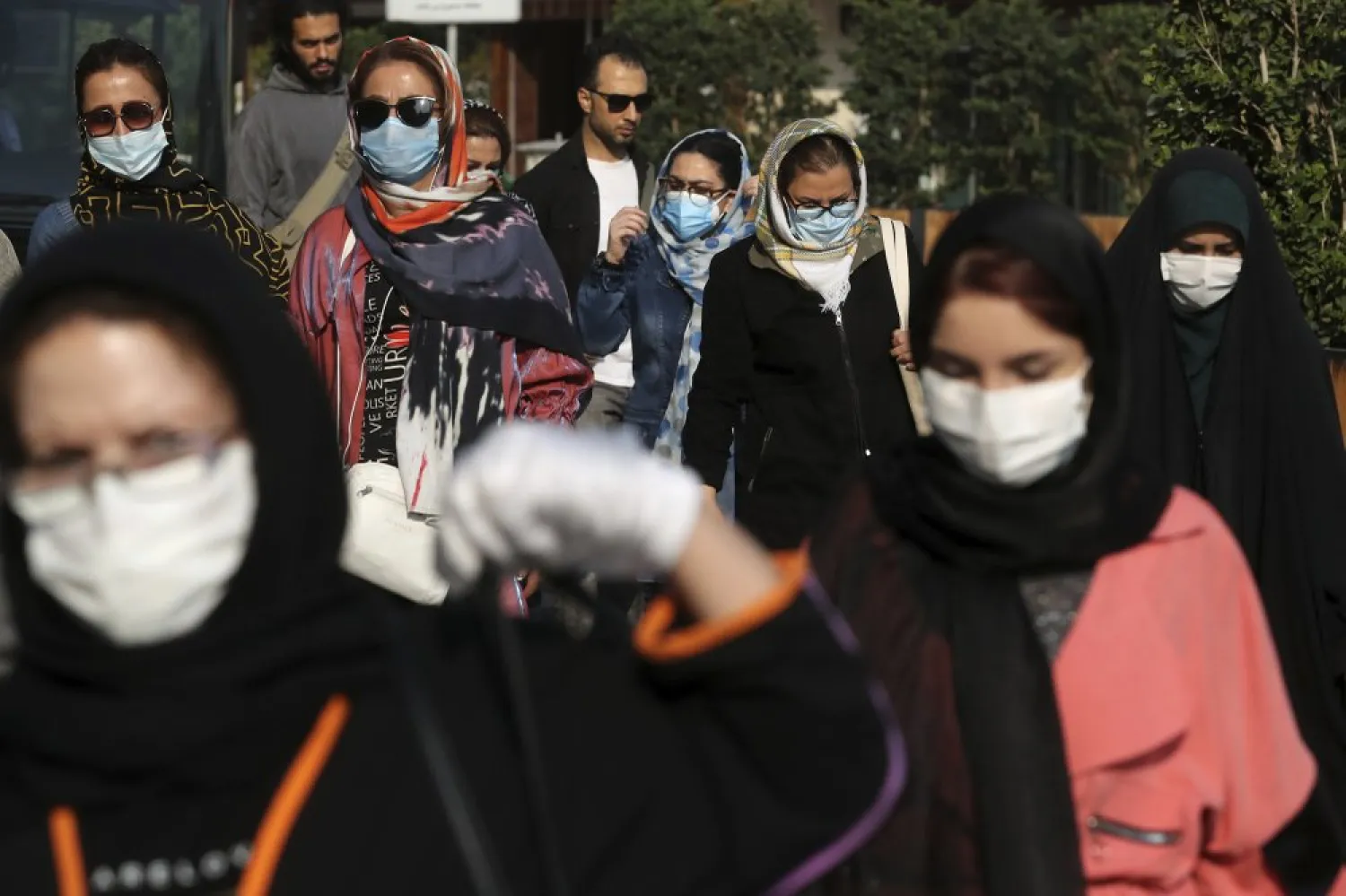 People wear protective face masks to help prevent the spread of the coronavirus in downtown Tehran, Iran, Sunday, Oct. 11, 2020. Iran announced on Sunday its highest single-day death toll from the coronavirus with 251 confirmed dead, the same day local media reported two senior officials had been infected and the nation's currency plunged to its lowest level ever. (AP Photo/Ebrahim Noroozi)
