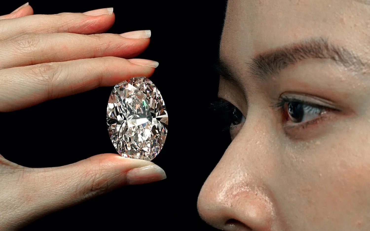 A 102.39 carat, D color, flawless diamond is displayed by a model at a Sotheby's auction room in Hong Kong Monday, Sept. 28, 2020. (AP)