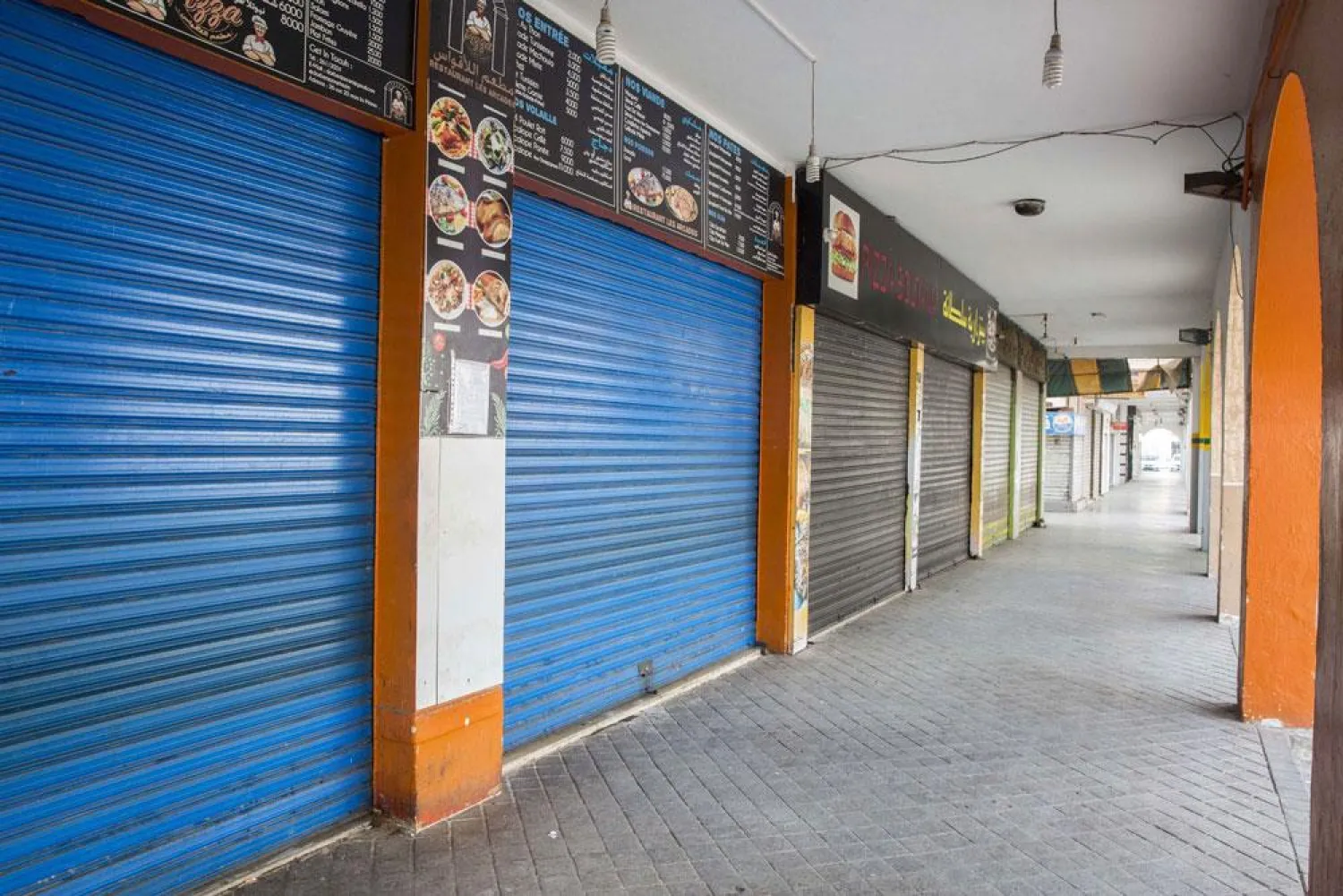 Restaurants and coffee-shops shuttered at a usually lively street in La Marsa outside Tunis. (AP)