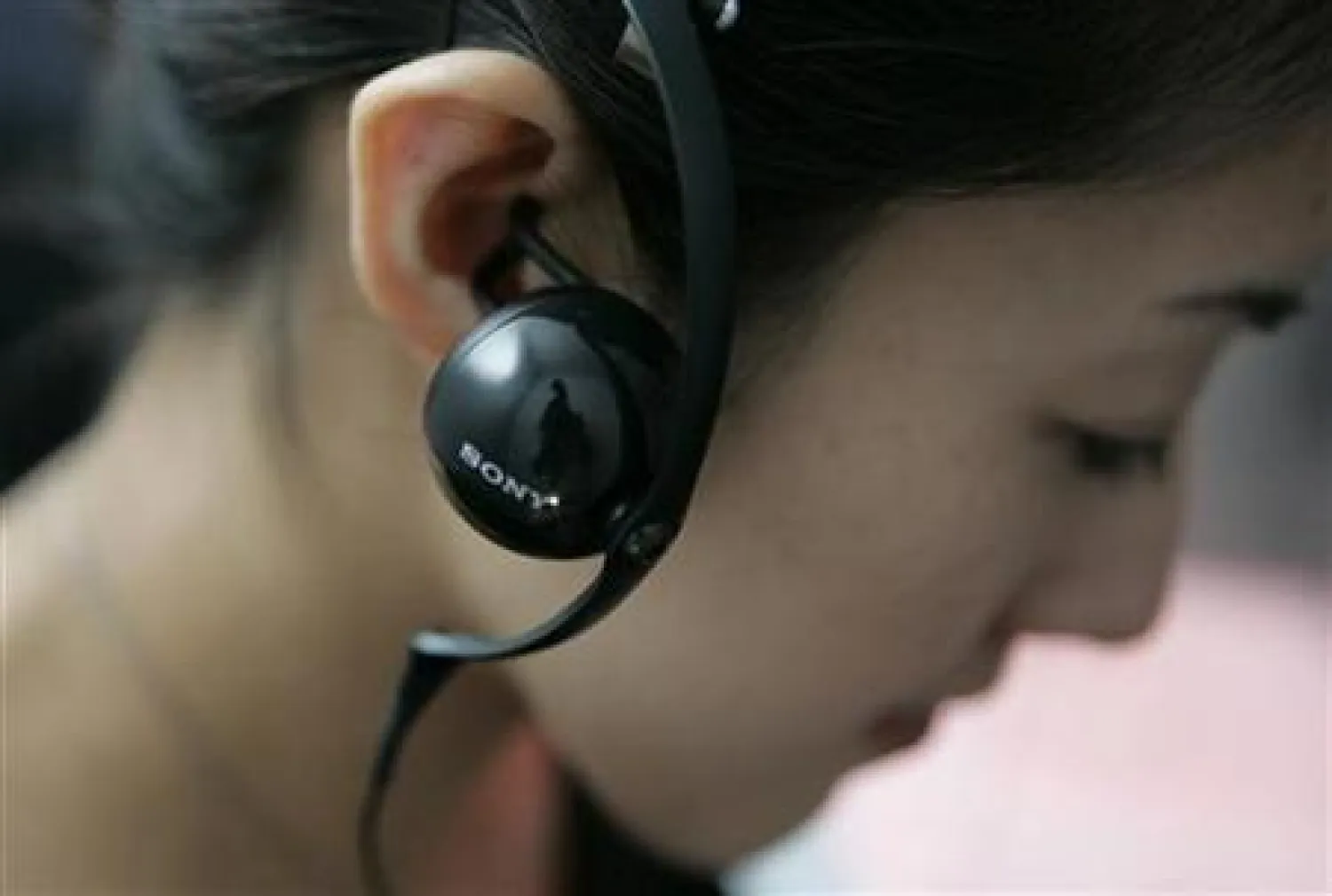 A woman wears Sony Corp's new "personal field speaker" headphone for a photograph at Sony Dealer Convention in Tokyo September 12, 2007. REUTERS/Yuriko Nakao

