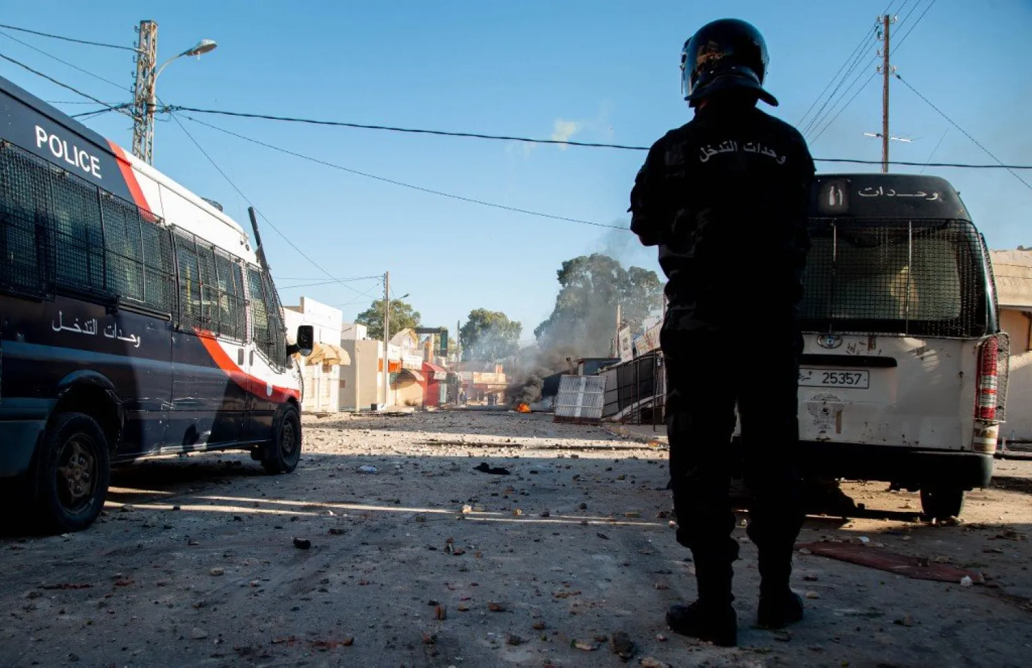 Police officer in a blocked street during protests following the death of merchant in Sbeitla, Kassarine (AFP)