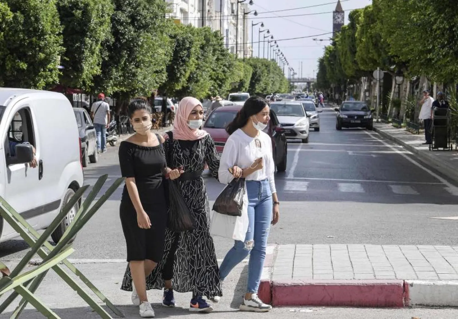 Women wearing masks across Avenue Habib Bourguiba in Tunis (AFP)