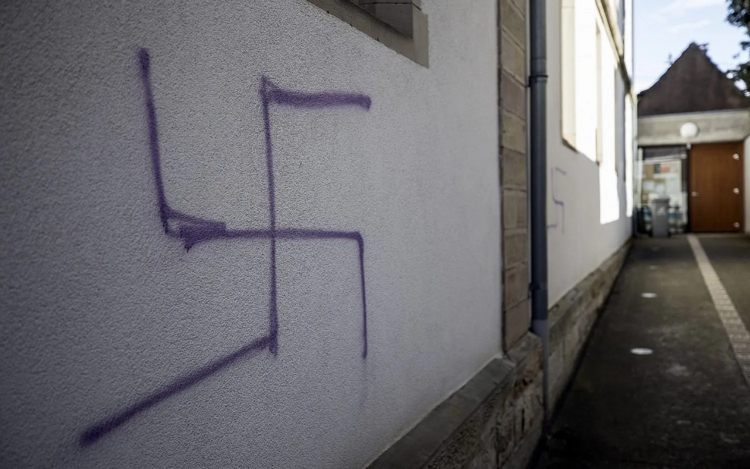 Illustrative: A swastika is seen on a sidewall of a former synagogue in Mommenheim, eastern France, March 4, 2019. (AP Photo/Jean-Francois Badias)