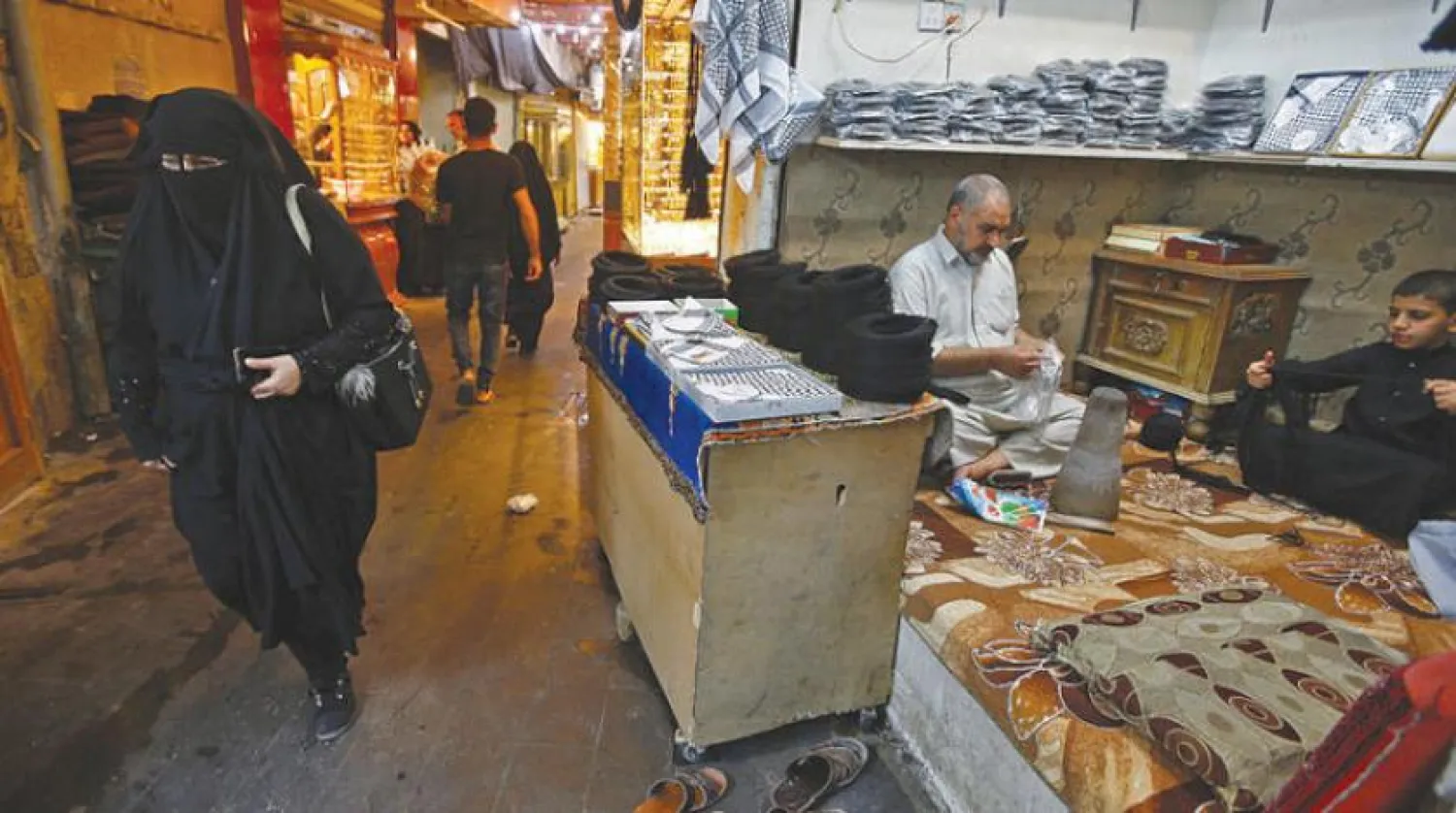 A man makes igals, tradition Arabic cords worn on heads, at a store in a market in Najaf, Iraq, October 14, 2020. REUTERS/Alaa Al-Marjani
