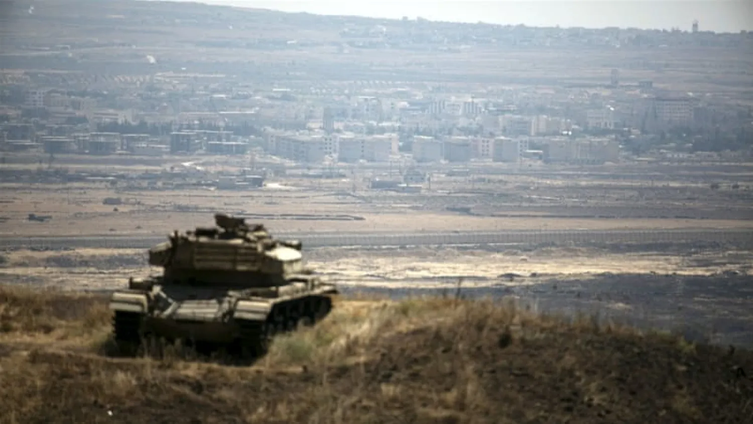 The Syrian area of Quneitra is seen in the background as an Israeli tank parks on a hill in the Israeli-occupied Golan Heights. Photo: Reuters