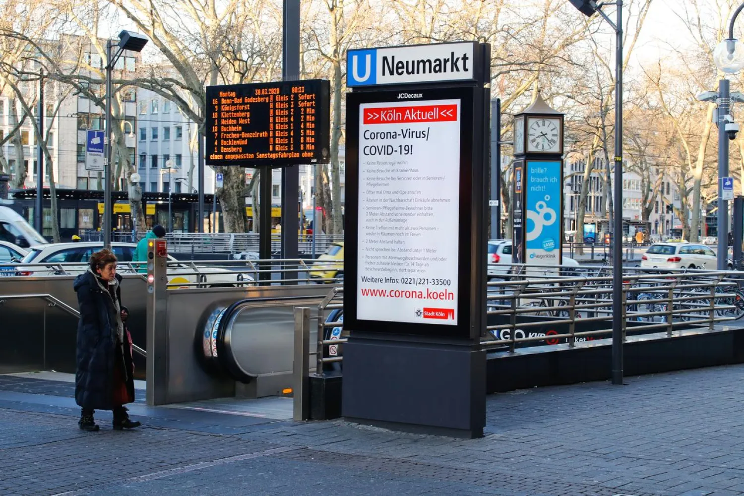 A board with corona informations is seen at the Neumarkt subway station, as the spread of coronavirus disease (COVID-19) continues in Cologne, Germany, March 30, 2020. REUTERS/Wolfgang Rattay
