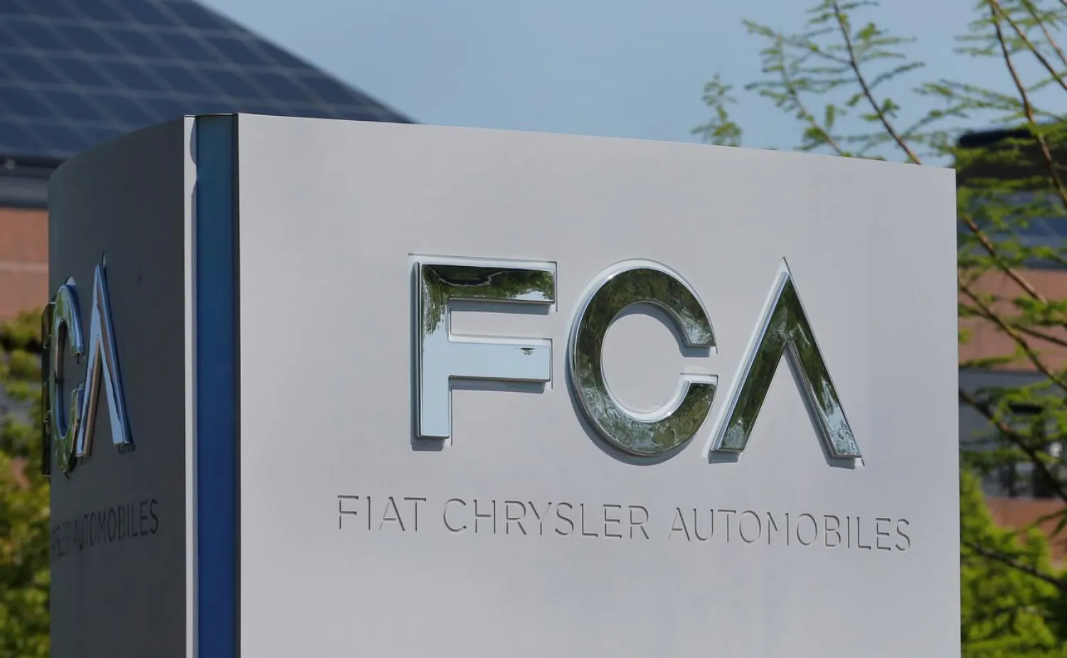 FILE PHOTO: A Fiat Chrysler Automobiles (FCA) sign is seen at its US headquarters in Auburn Hills, Michigan, US May 25, 2018. REUTERS/Rebecca Cook