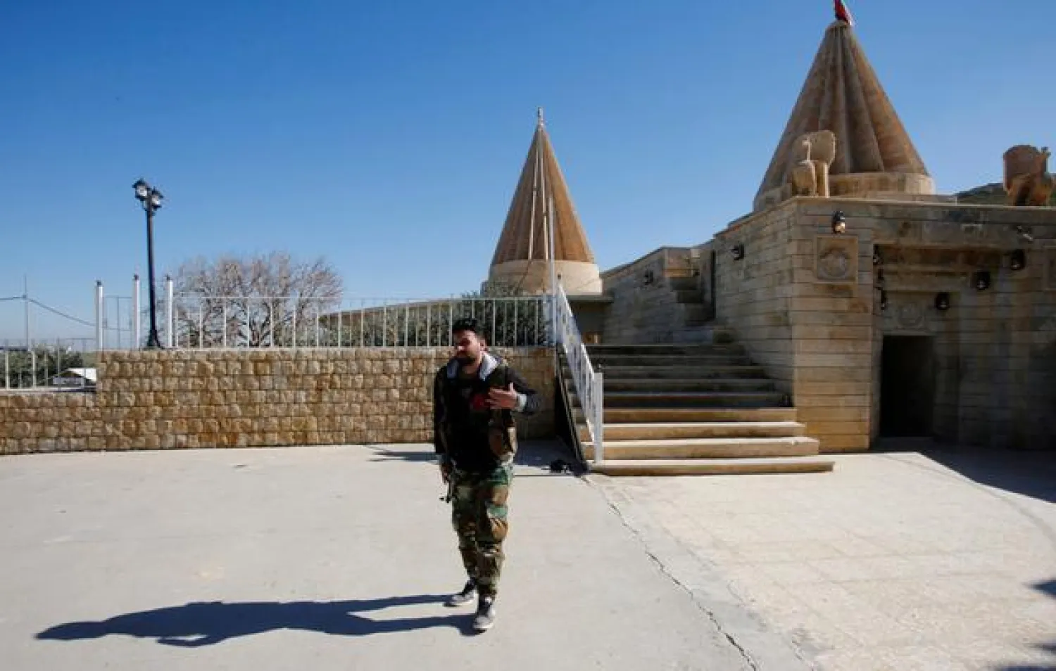 A Yazidi fighter walks near Yazidi temple Sharaf al-Din, in Sinjar, Iraq February 4, 2019. Picture taken February 4, 2019. REUTERS/Khalid al-Mousily/File Photo