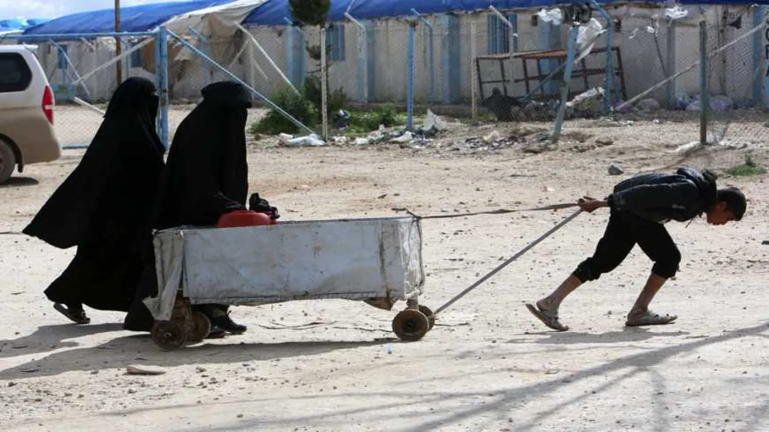 A boy pulls a cart at al-Hol displacement camp in Hasaka governorate, Syria, April 1, 2019.  Photo by REUTERS/Ali Hashisho.