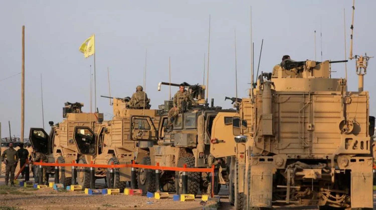 American soldiers stand near military trucks, at al-Omar oil field in Deir Ezzor, Syria March 23, 2019. (Reuters)
