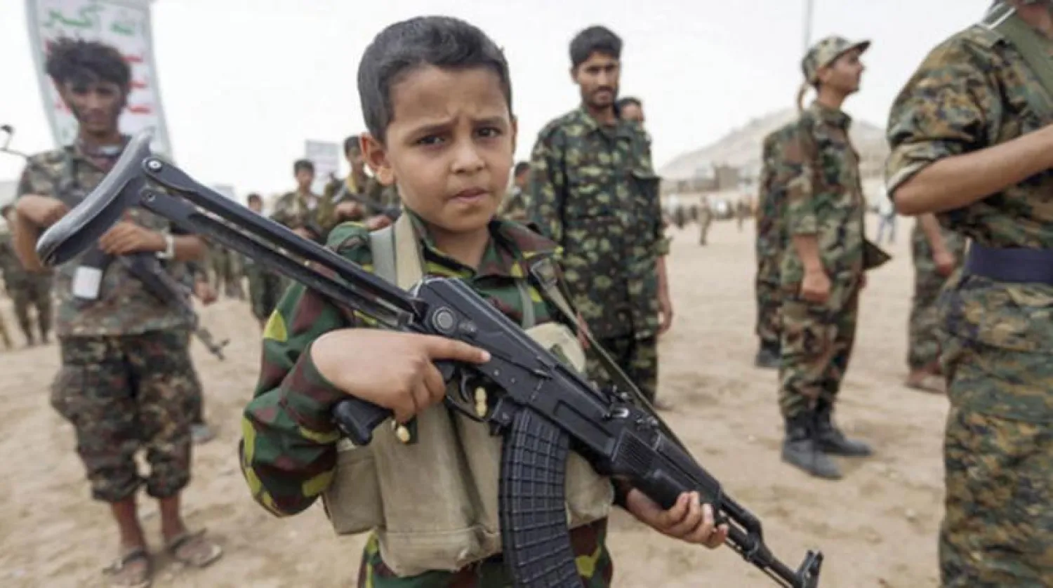 A Yemeni child with his weapon during a gathering of new Houthi fighters in Sanaa (AFP)
