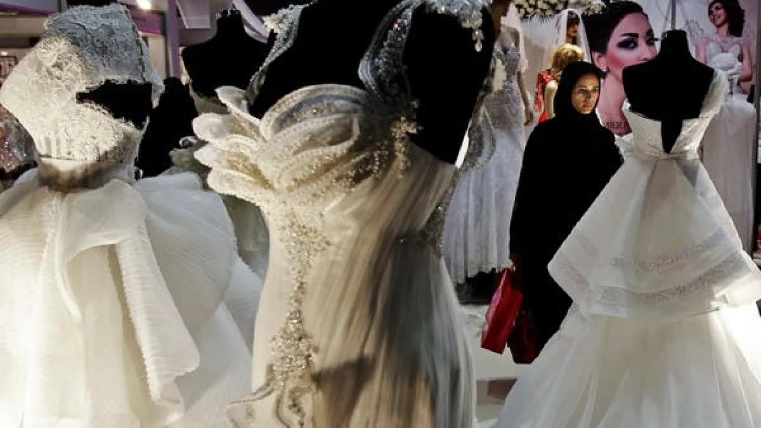 An Emirati woman looks at wedding gowns at a bridal exhibition in Dubai, United Arab Emirates. (File photo: AP)
