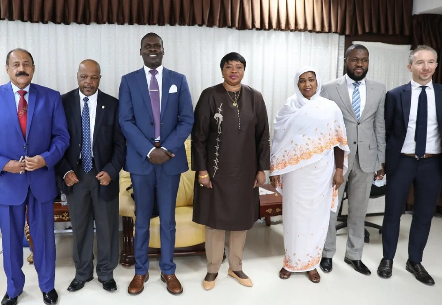 Prosecutor of the International Criminal Court, Fatou Bensouda (C), poses with Sudanese officials, including Justice Minister Nasruddin Abdel Bari (3rd L), during her visit to Khartoum. (AFP)