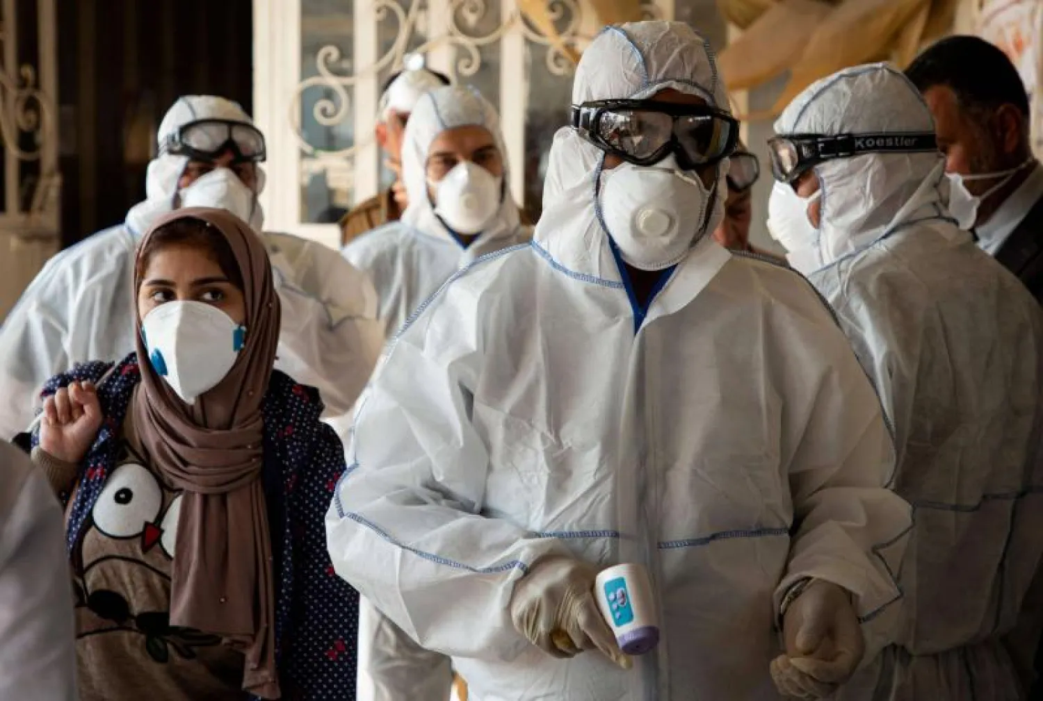 A medical team checks on travellers at the Shalamjah border crossing, some 15 kms southeast of the city of Basra, upon their return from Iran on February 21. (AFP)
