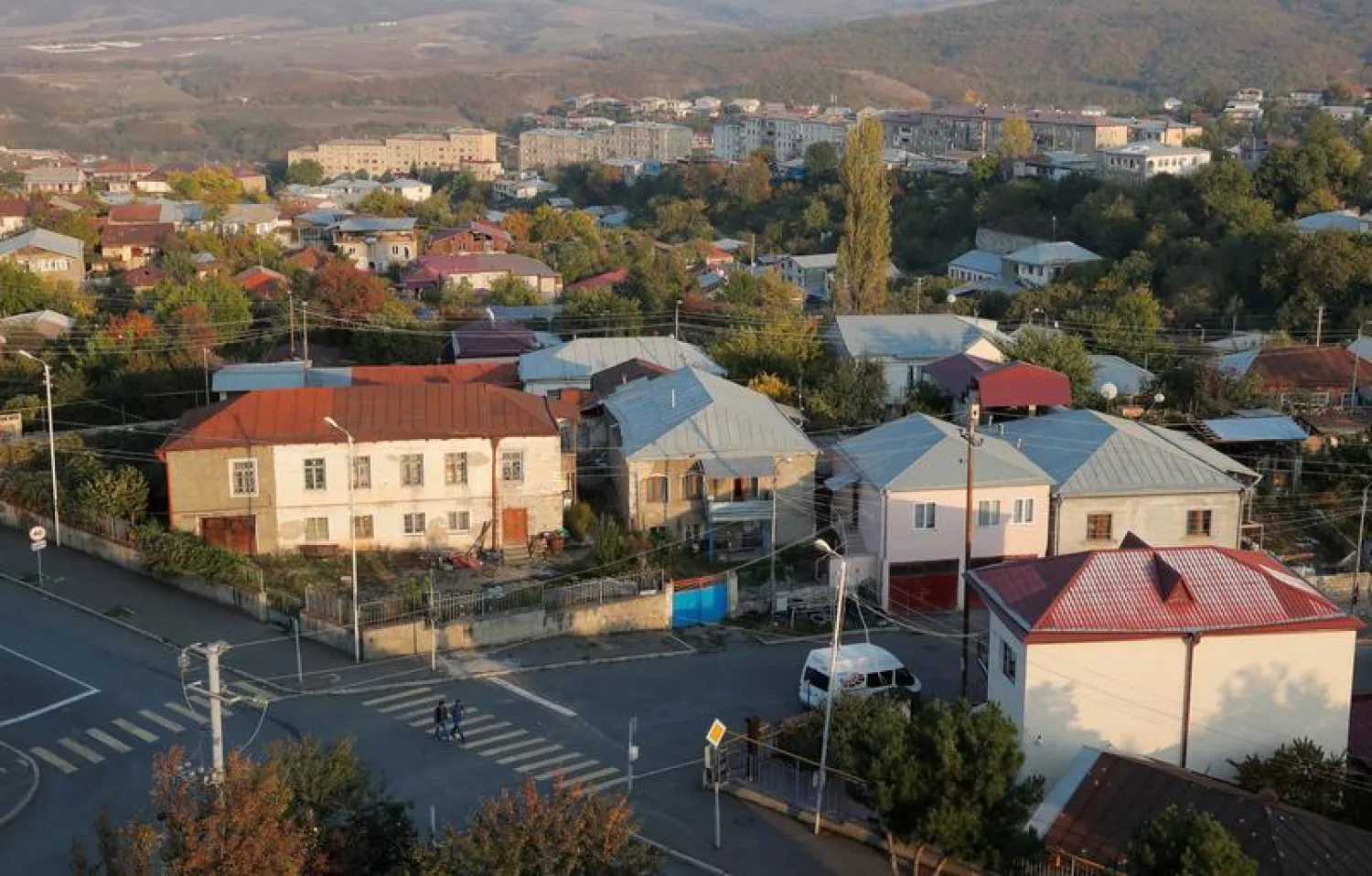 People cross a street in Stepanakert, the capital of the breakaway region of Nagorno-Karabakh, October 19, 2020. REUTERS/Stringer