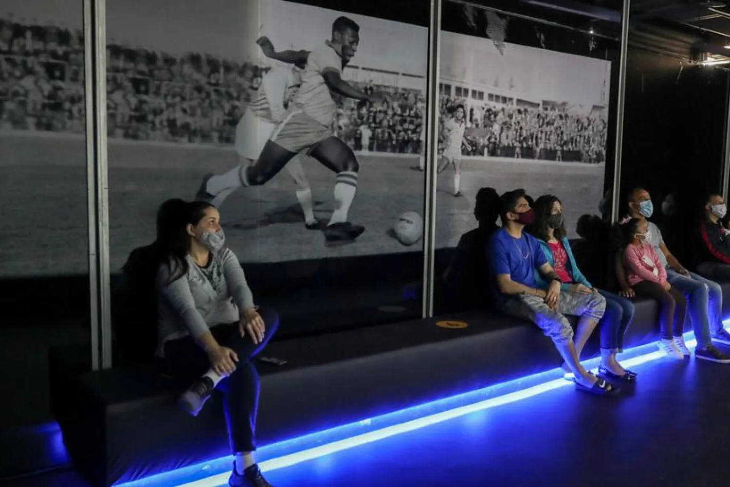 People watch a film about Brazilian football legend Pele at an exhibition marking his 80th birthday at the Soccer Museum in Sao Paulo, Brazil October 17, 2020. (Reuters)