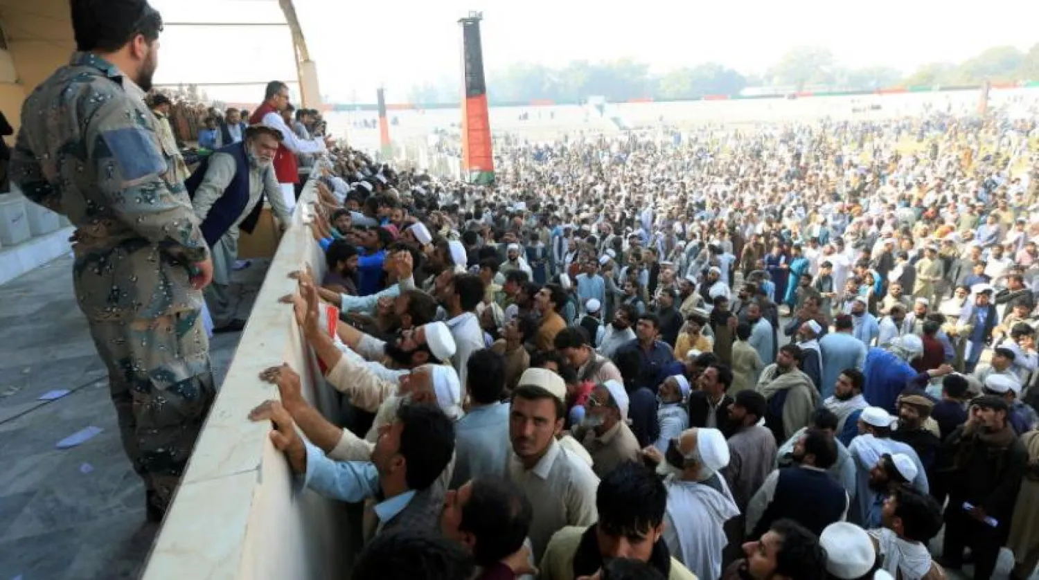 Afghan men wait to receive tokens needed to apply for the Pakistan visa, after people were killed in a stampede in Jalalabad, Afghanistan October 21, 2020. REUTERS/Parwiz