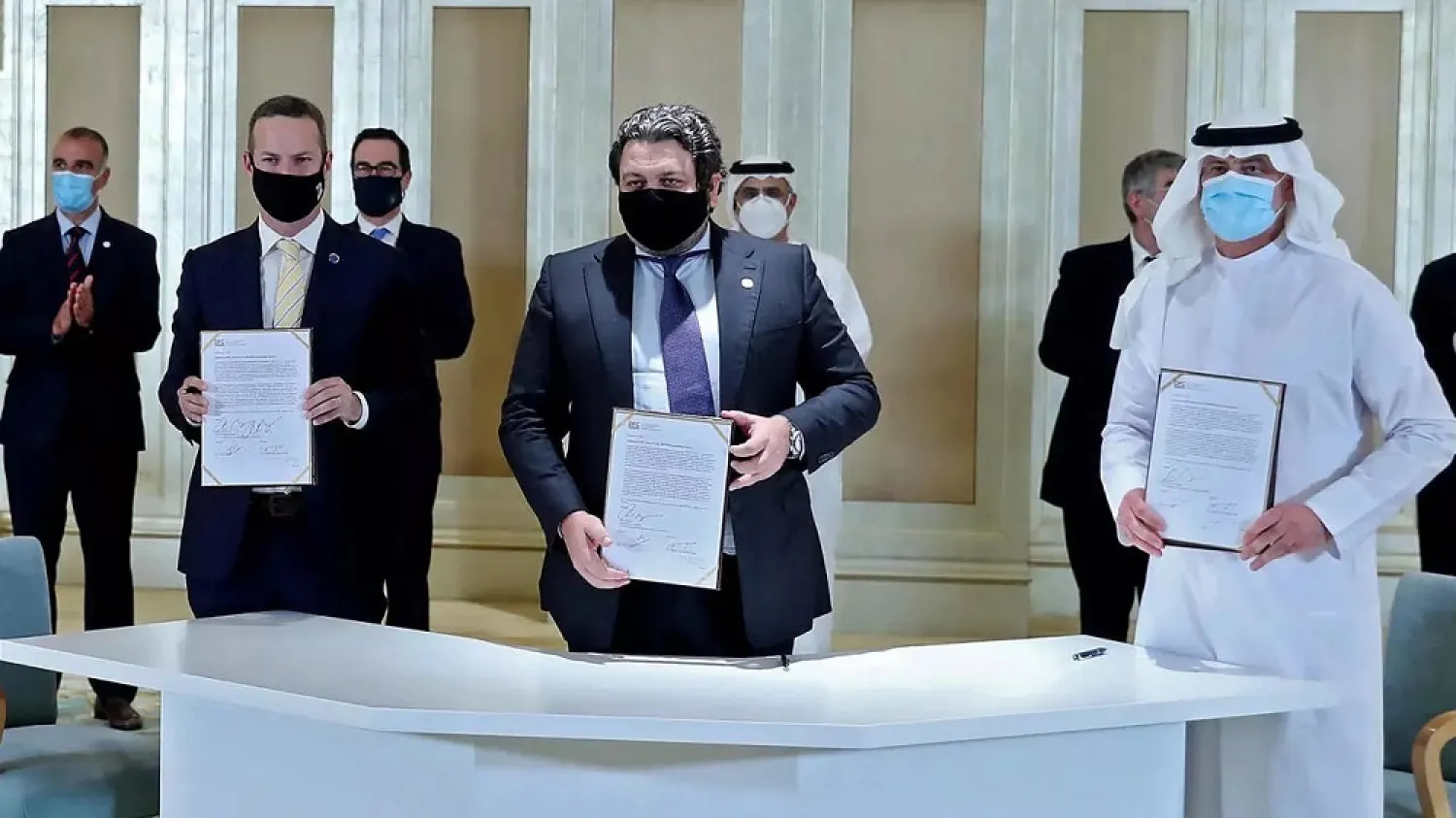 Emirati and Israeli delegates sign an agreement at the first Abraham Accords Business Summit in Abu Dhabi in the presence of US Treasury Secretary Steven Mnuchin on October 19. (WAM)