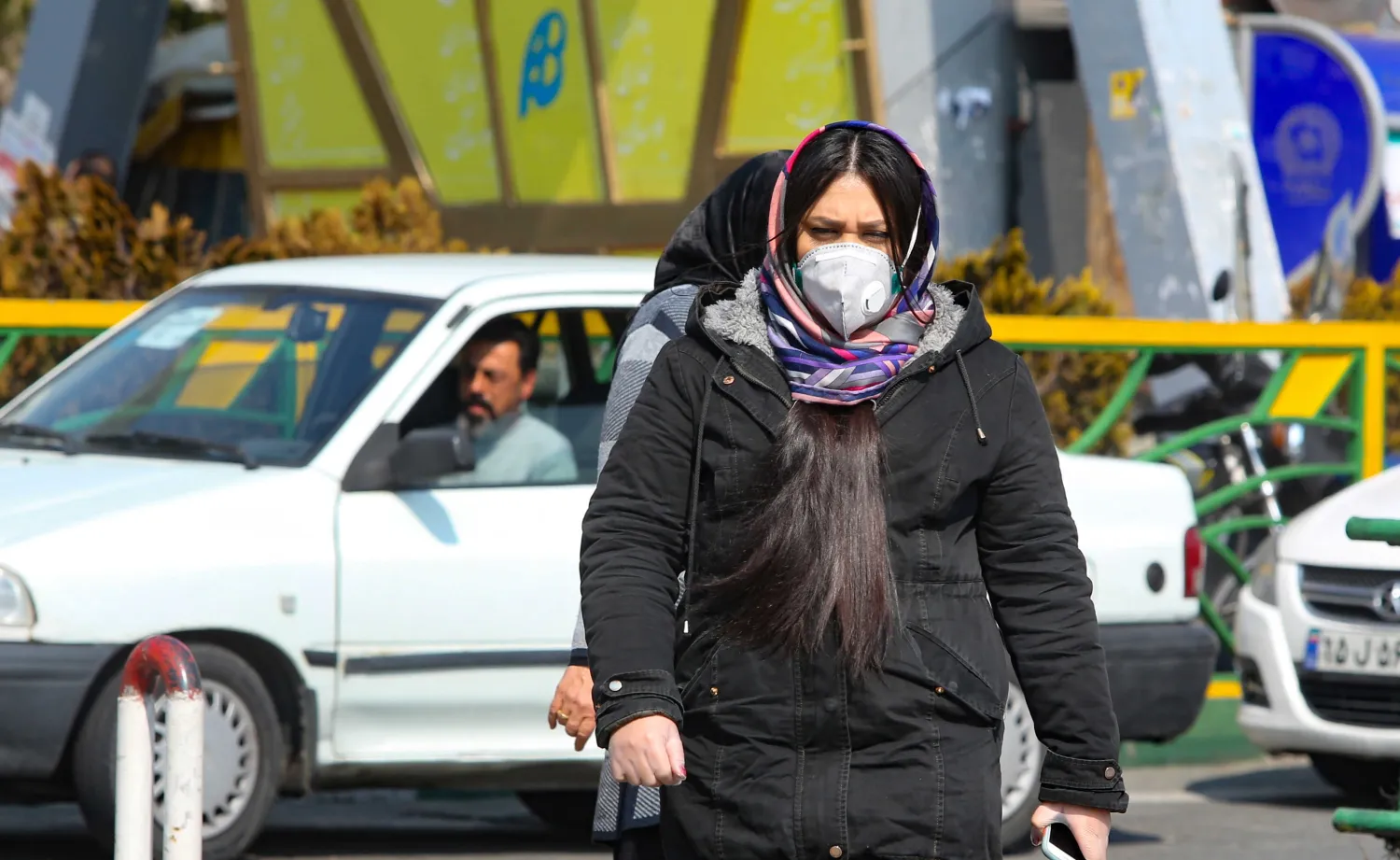 A woman wearing a protective mask crosses a street in Iran's capital Tehran, Feb. 22, 2020. AFP