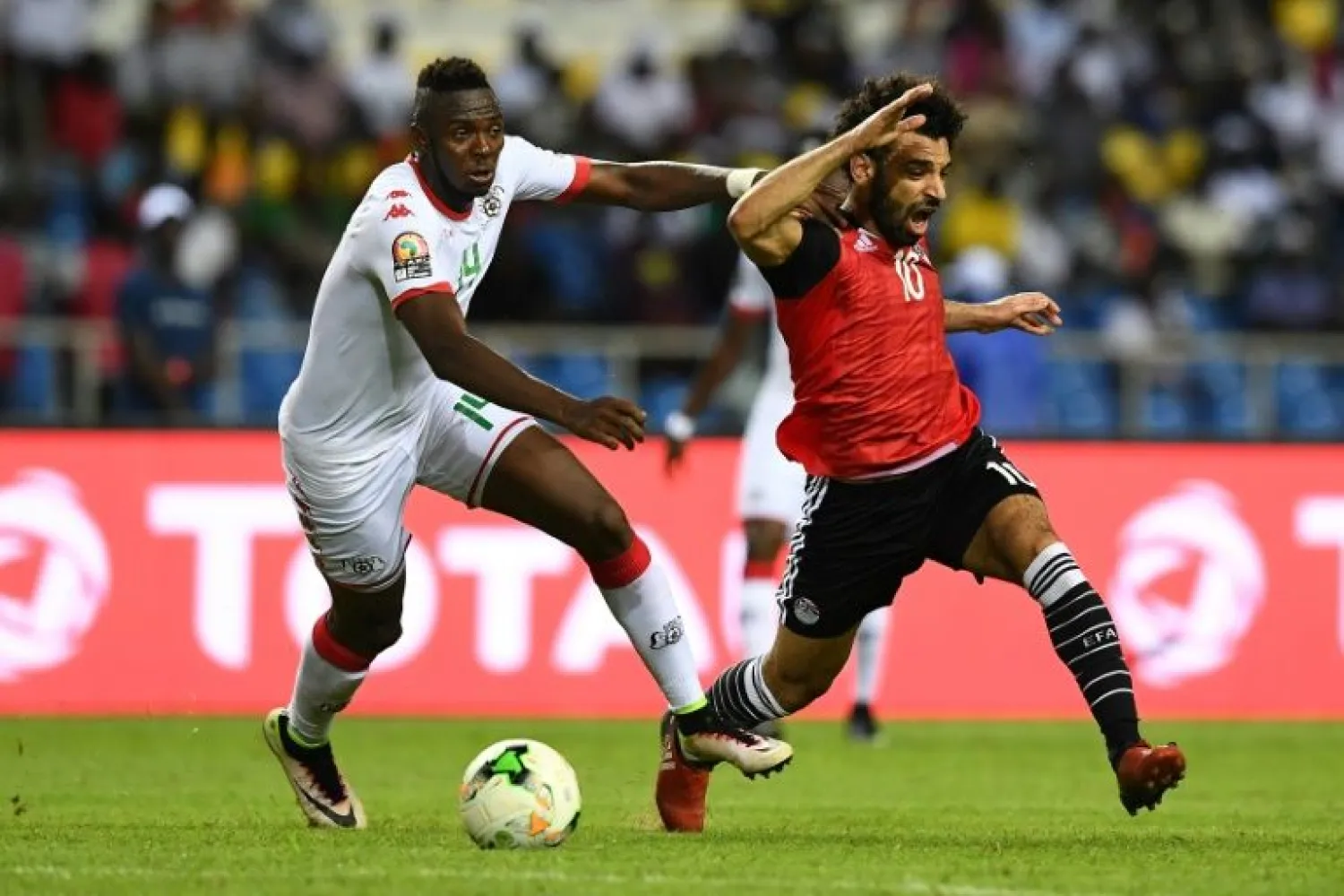 Renaissance Berkane defender Issoufou Dayo (L) challenges Mohamed Salah while playing for Burkina Faso against Egypt in a 2017 Africa Cup of Nations semi-final. | AFP