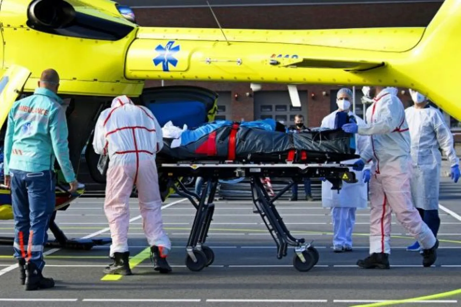 Medical staff carry a patient infected with Covid-19 for an evacuation by helicopter from the Flevo Hospital in Almere to Munster, Germany | AFP