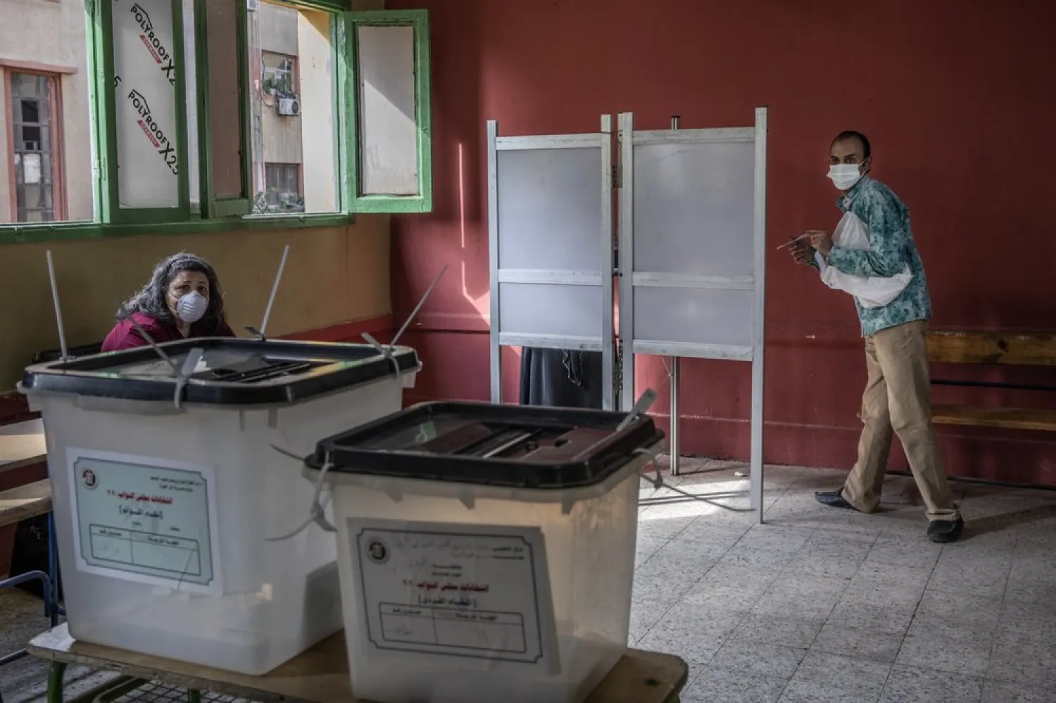 A man prepares to cast ballot on the first day of the parliamentary election inside a polling station in Giza, Egypt, Saturday, Oct. 24, 2020. (AP Photo/Nariman El-Mofty)
