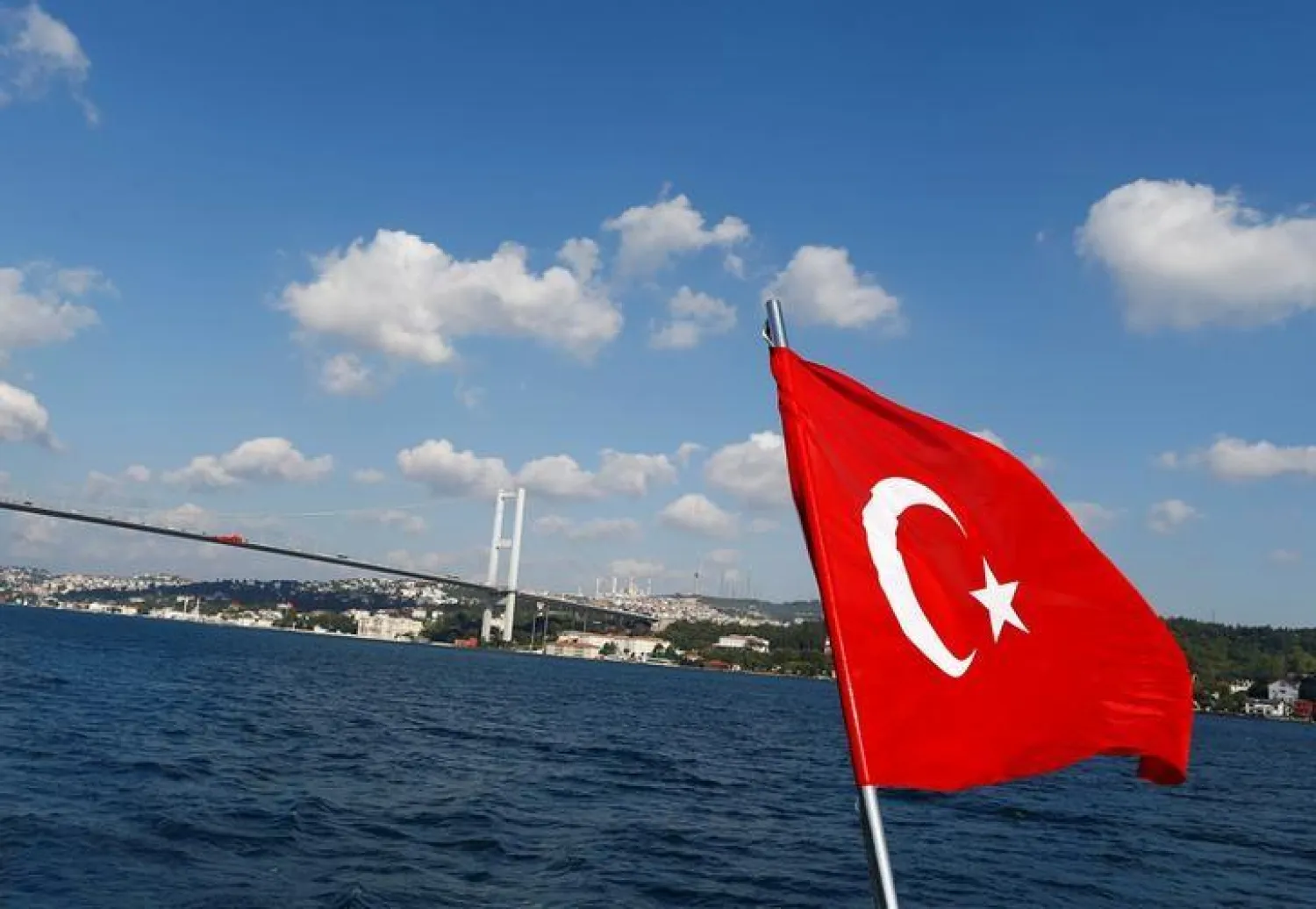 A Turkish flag is pictured on a boat with the Bosphorus bridge in the background in Istanbul, Turkey, August 6, 2016. REUTERS/Osman Orsal
