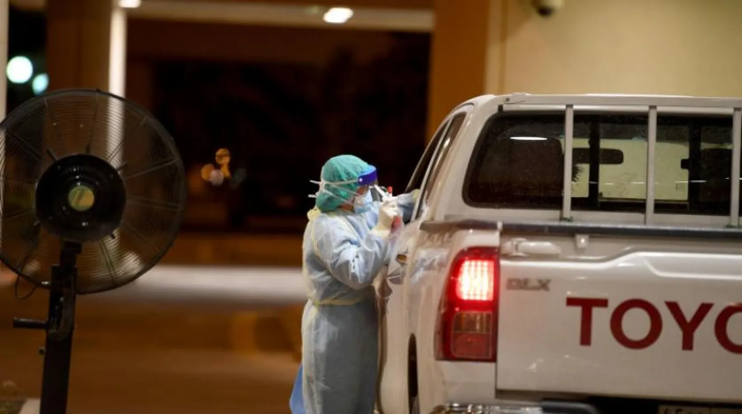 A health care worker performs a PCR test on a Saudi citizen. Photo: Bashir Salih 