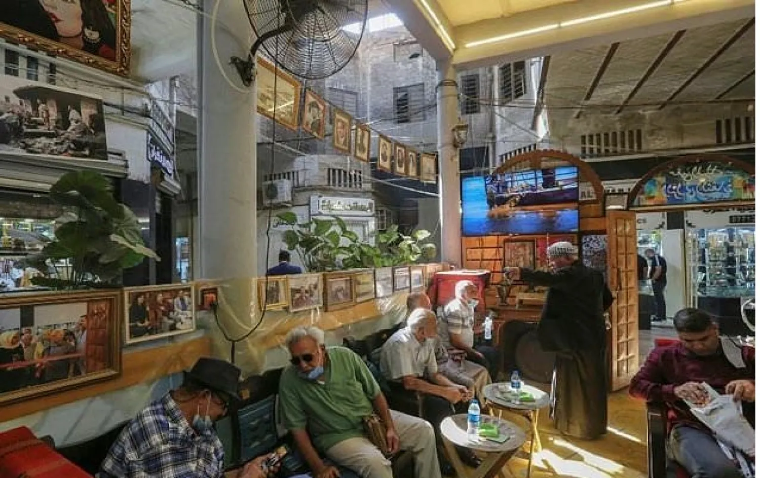 Iraqis sit at a traditional cultural coffee shop, one of several gathering spots for the country's intellectuals, in the capital Baghdad's al-Rashid street. AFP