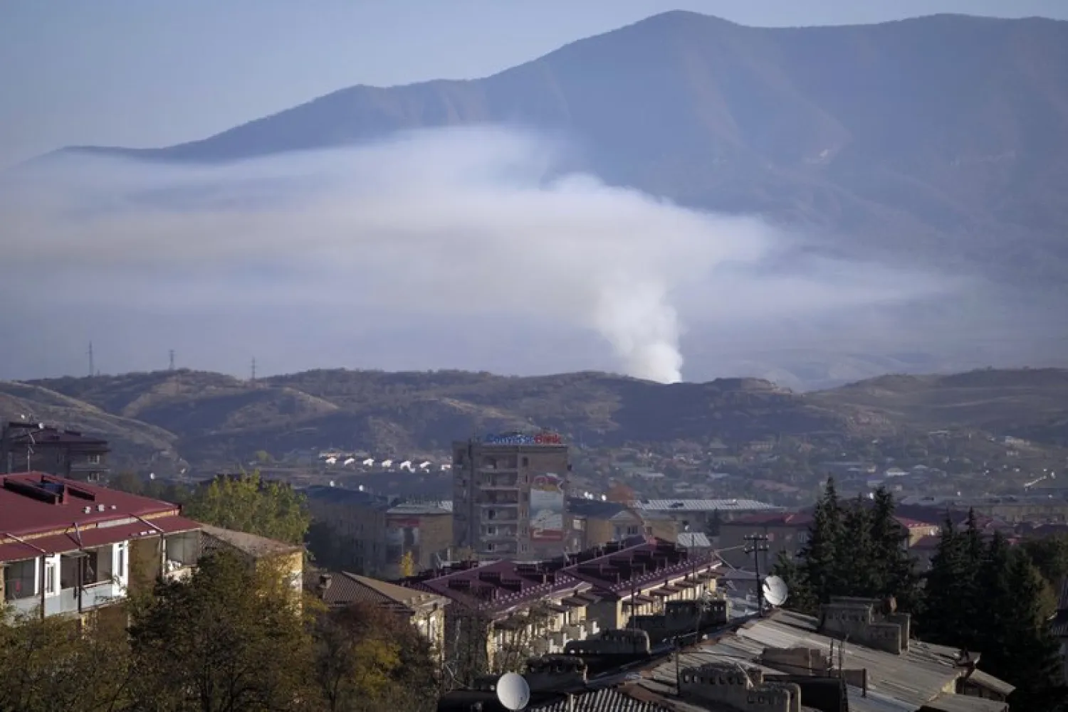 Smoke rises after shelling by Azerbaijan's artillery during a military conflict in Stepanakert, the separatist region of Nagorno-Karabakh, Saturday, Oct. 24, 2020. The heavy shelling forced residents of Stepanakert, the regional capital of Nagorno-Karabakh, into shelters, as emergency teams rushed to extinguish fires. Nagorno-Karabakh authorities said other towns in the region were also targeted by Azerbaijani artillery fire. (AP Photo)