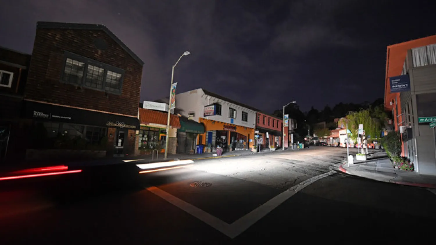 A vehicle drives up Mountain Blvd. in the Montclair neighborhood after the power has been shut off due to high winds in Oakland, Calif., Sunday, Oct. 25, 2020. (Jose Carlos Fajardo/Bay Area News Group via AP)/Bay Area News Group via AP)