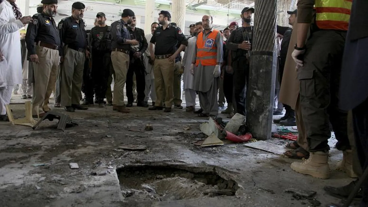 Police officers examine the site of bomb explosion in an Islamic seminary in Peshawar, Pakistan, Tuesday, Oct. 27, 2020.   -   Copyright  AP Photo/Muhammad Sajjad
