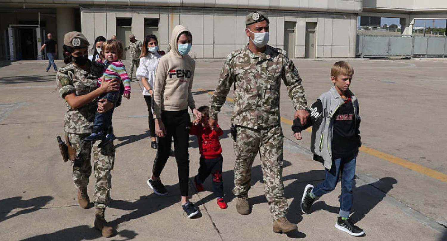 عناصر من الجيش اللبناني يرافقون أطفالاً من ألبانيا نُقلوا من شمال شرقي سوريا (أ.ب)