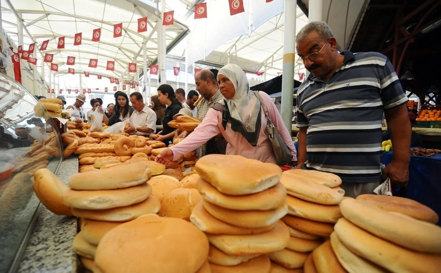 People shop at a market in Tunisia. (AFP)