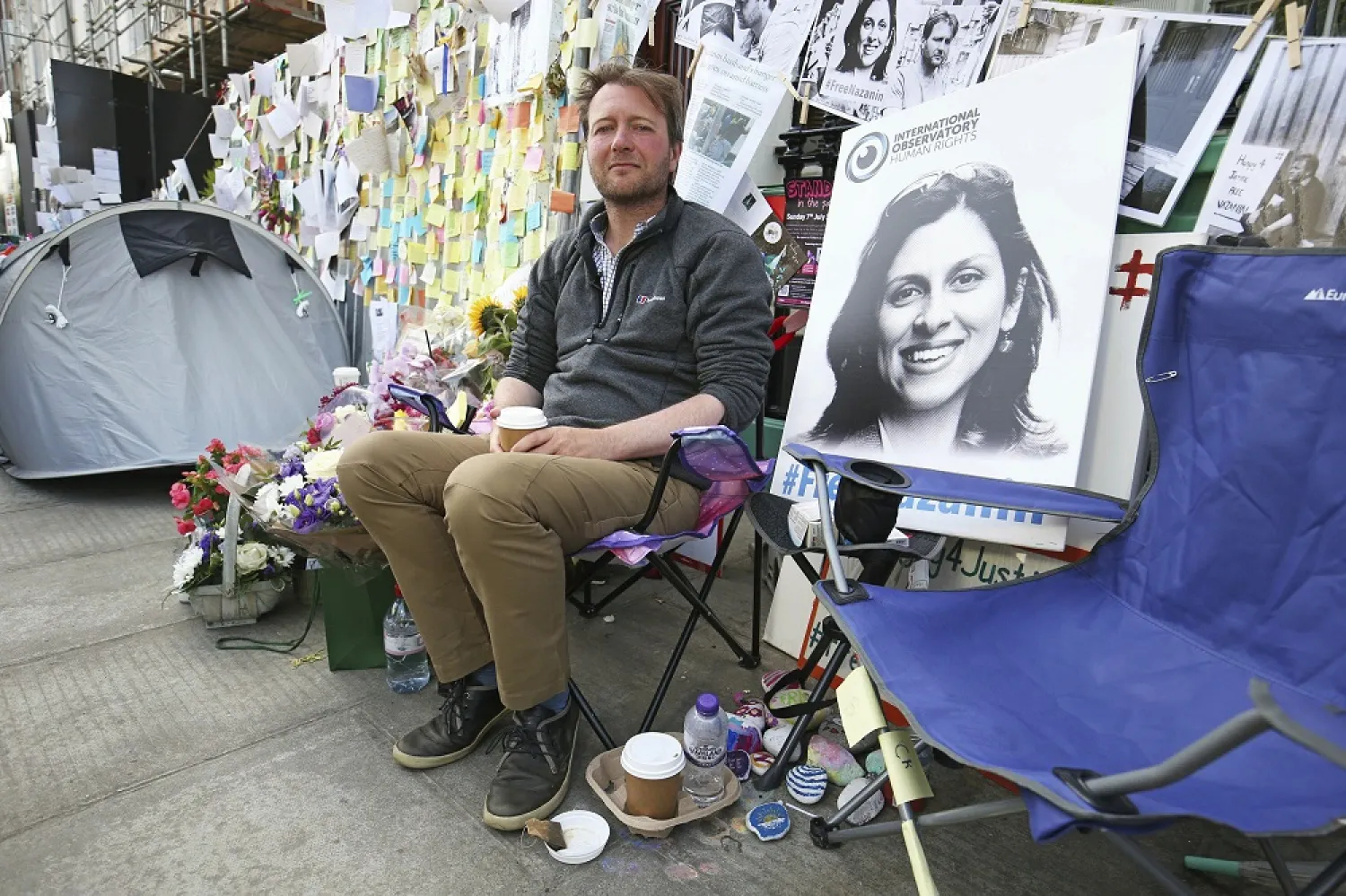 Richard Ratcliffe, the husband of detained Nazanin Zaghari-Ratcliffe, seen in poster, outside the Iranian Embassy in London, June 29, 2019. (AP)