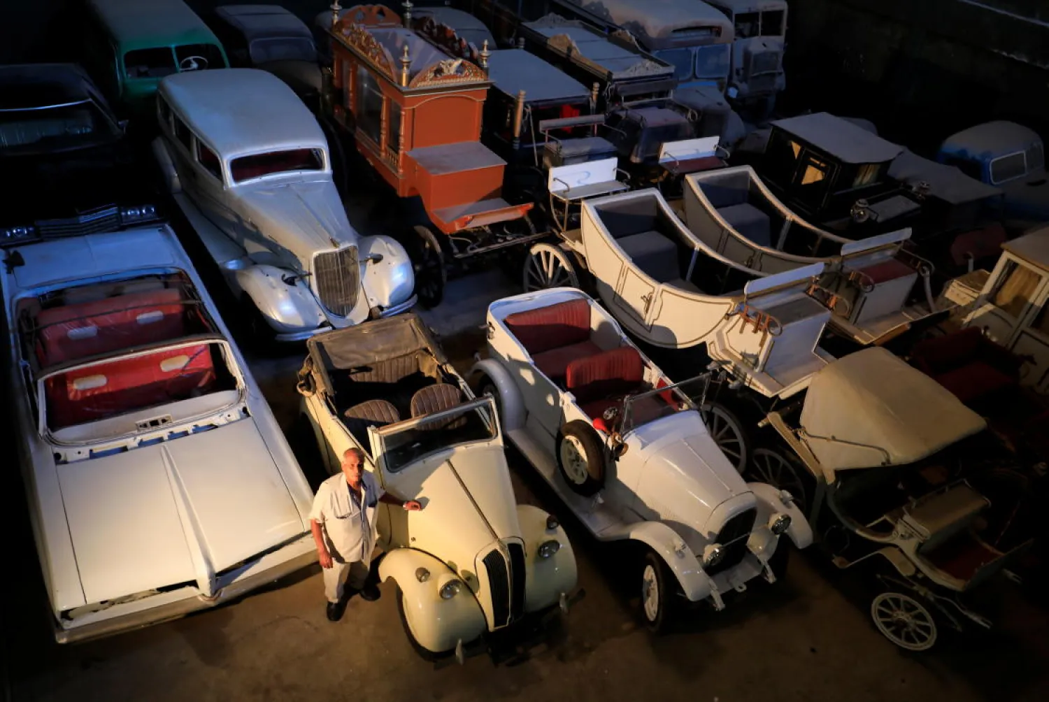 Sayed Sima stands next to a British Standard Flying Eight Tourer - 1948 automobile in his store where he has his exhibition of old cars, in the Giza suburb of Abu Rawash, Egypt October 25, 2020. (Reuters)