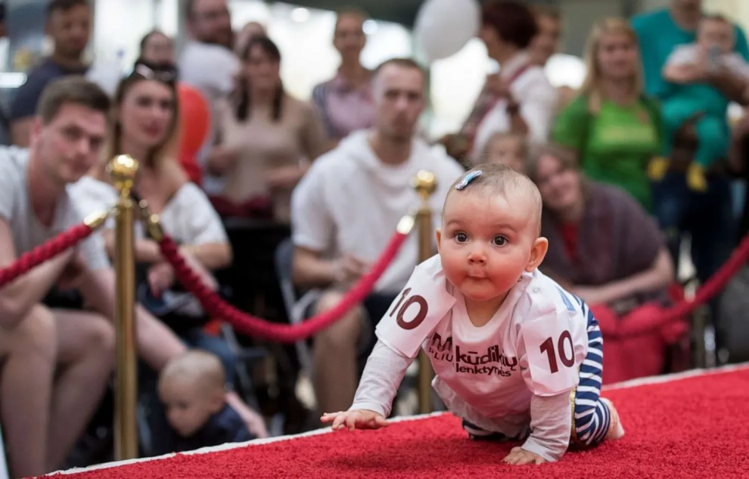 A baby crawls during the Baby Race event to mark international Children's Day in Vilnius, Lithuania, June 1, 2019. Mindaugas Kulbis/AP
