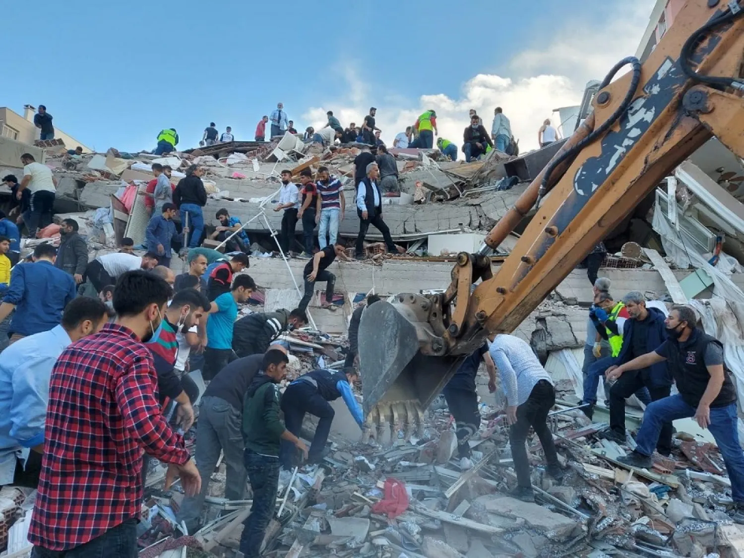 Locals and officials search for survivors at a collapsed building in Izmir, Turkey, after a strong earthquake struck the Aegean Sea on October 30, 2020. (Reuters)