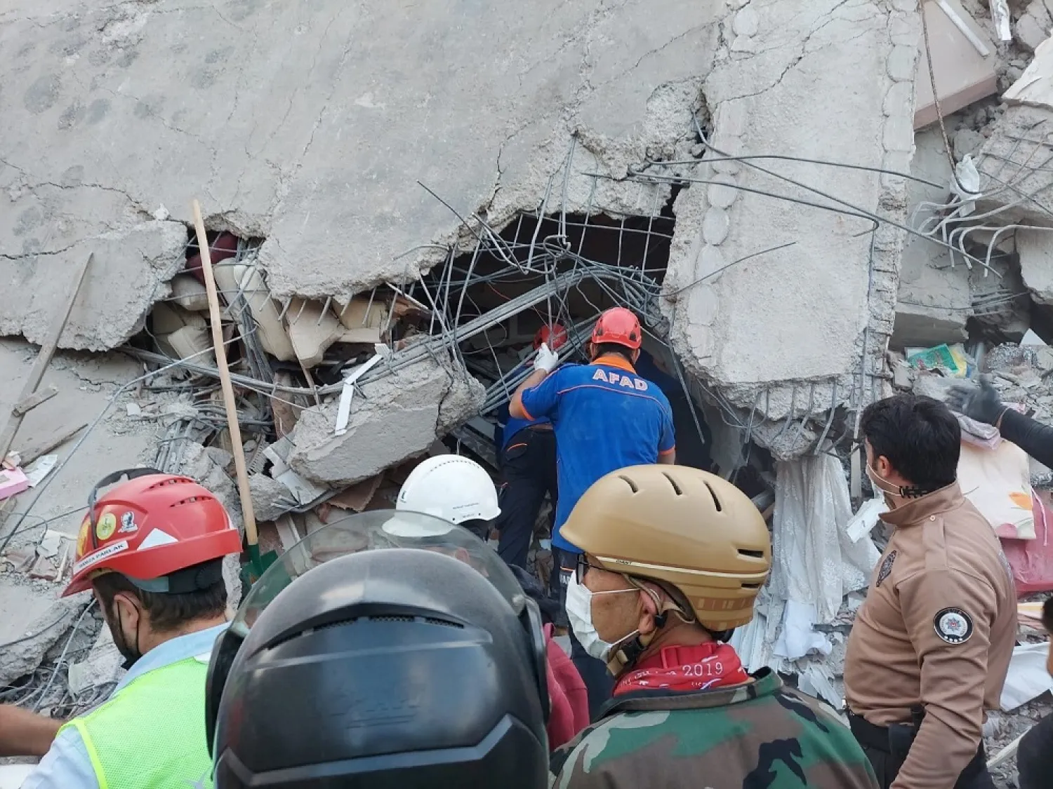 People search for survivors at a collapsed building after a strong earthquake struck the Aegean Sea where some buildings collapsed in Izmir, Turkey, Oct. 30, 2020. (Reuters)