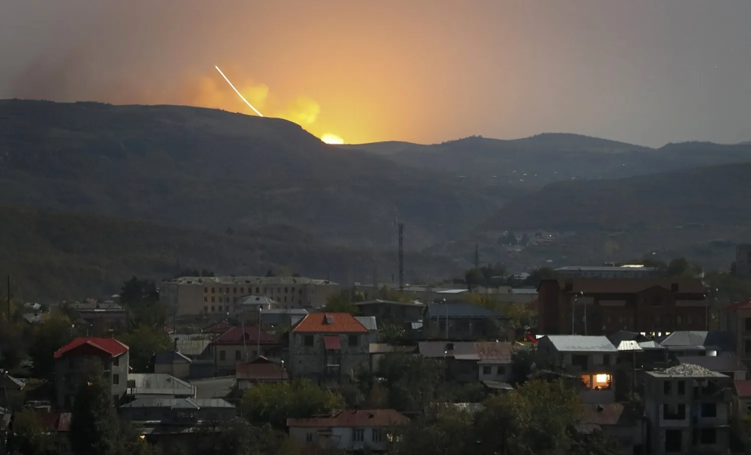 Explosions are seen behind the mountains during a military conflict outside Stepanakert in Nagorno-Karabakh, Oct. 30, 2020. (AP)