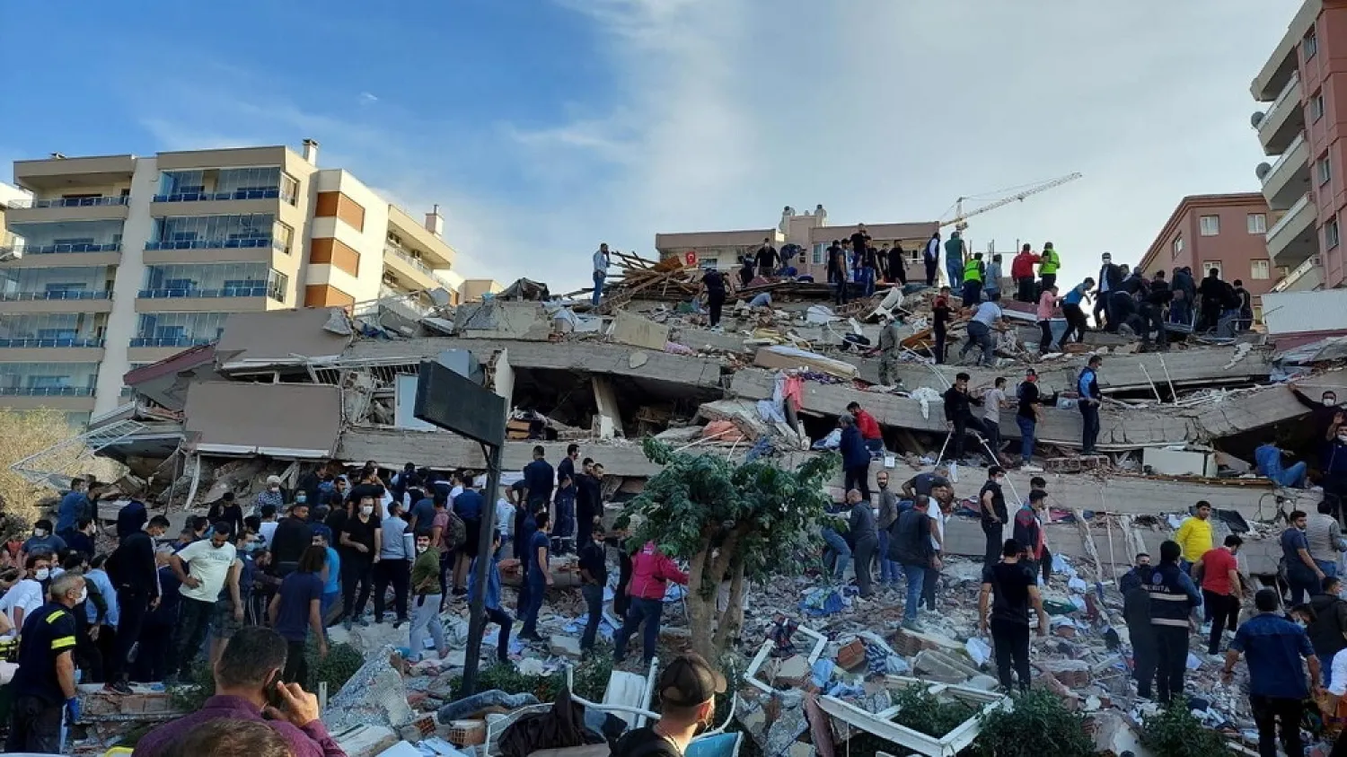 Locals and officials search for survivors at a collapsed building after a strong earthquake struck the Aegean Sea on Friday. (Reuters)