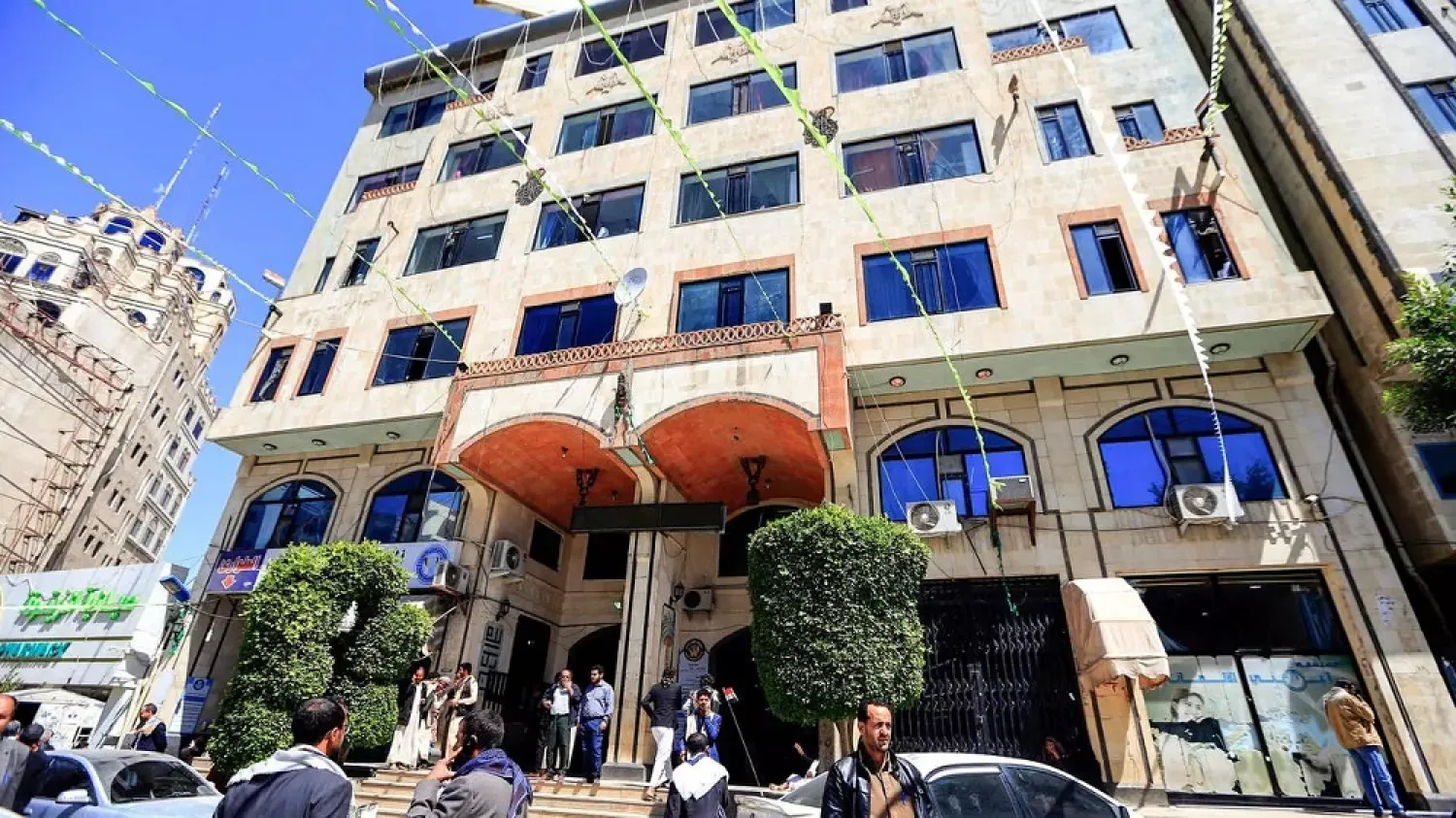 People wait outside a hospital in Sanaa on Tuesday after Hassan Zaid was shot while driving. (AFP)