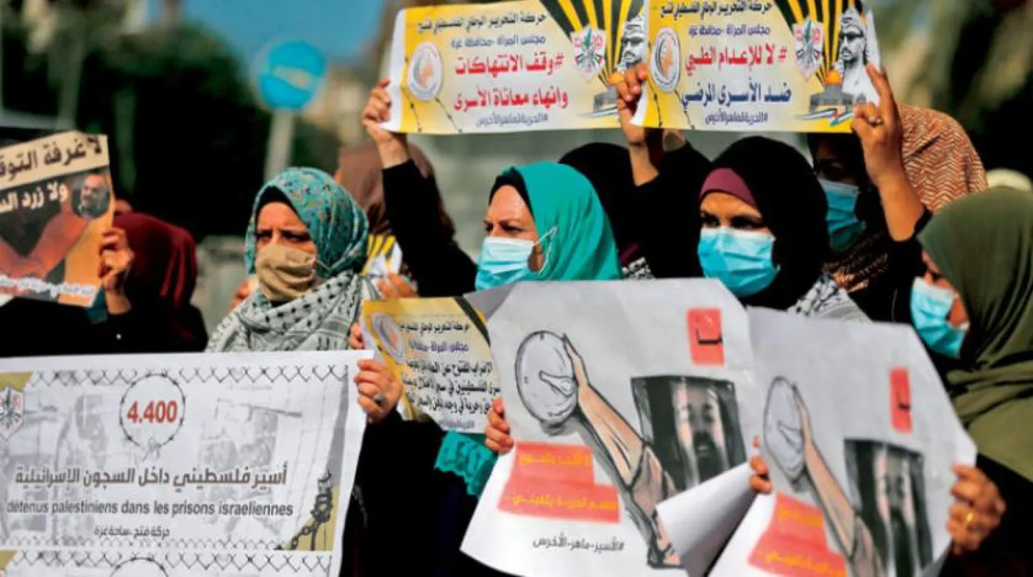 Palestinian women during a gathering to demand the release of Maher Al-Akhras, who has been in administrative-detention, in Gaza on October 26, 2020 (AFP) 


