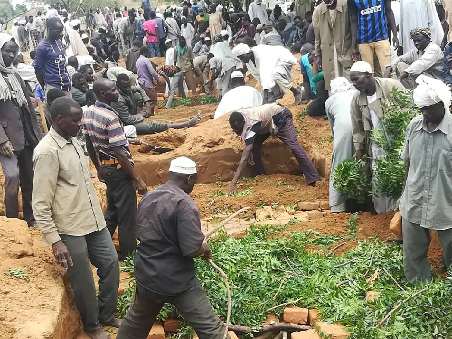 Residents dig a mass grave for victims of an attack that left over 60 dead in the village of Masteri in west Darfur, Sudan, July 27, 2020. (AP)
