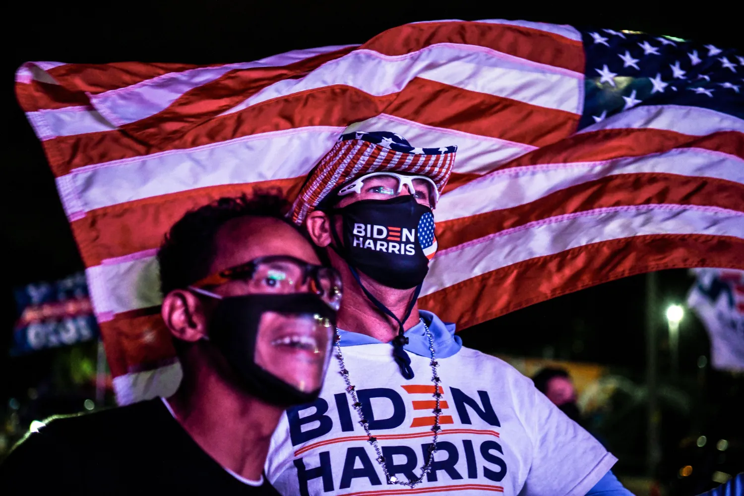 أليكس سواريز (يسار) ورالف ريتشارد (يمين) يهتفان لتأييد مرشح الحزب الديمقراطي جو بايدن أثناء حضورهما حفل لمتابعة نتائج الانتخابات في ميامي بولاية فلوريدا (أ.ف.ب)