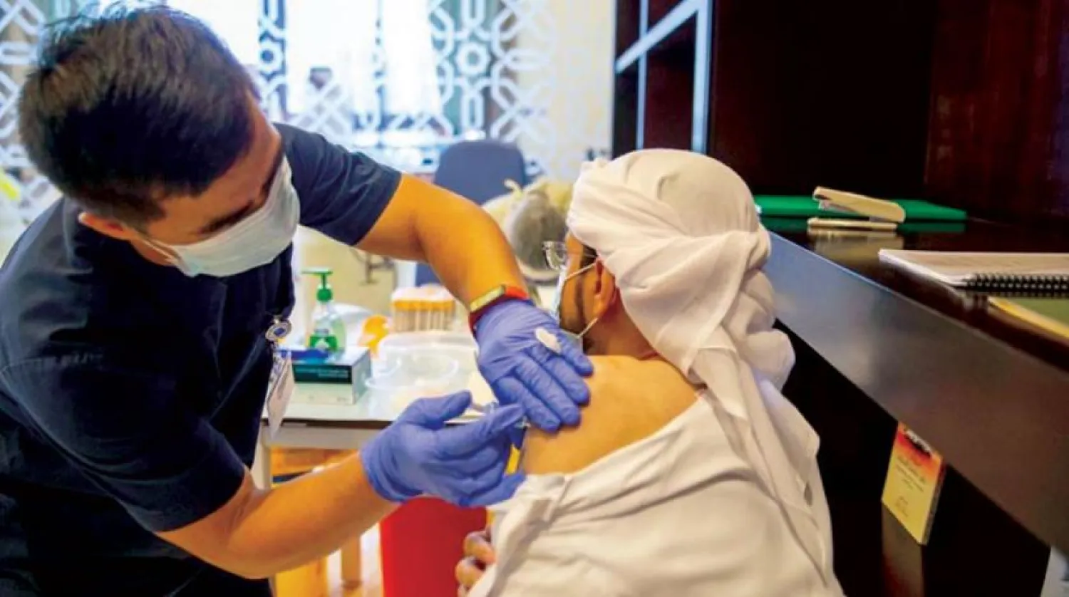 A person receives COVID-19 vaccine. WAM